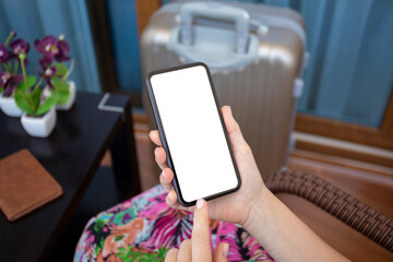female hands holding phone with isolated screen and suitcase