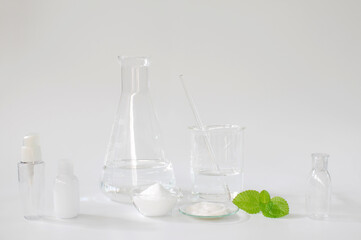 natural beauty organic botany with herb leaves scientific equipment researched, cosmetic bottle containers with blank label