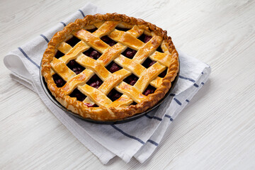 Yummy Homemade Cherry Pie on a white wooden table, side view. Space for text.