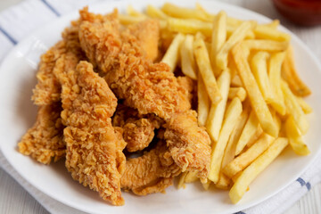 Homemade Crispy Chicken Tenders and French Fries, low angle view. Close-up.