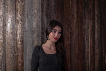 Fototapeta premium Beautiful multicultural young woman against wooden background. Portrait of pretty young muslim woman with red lipstick.