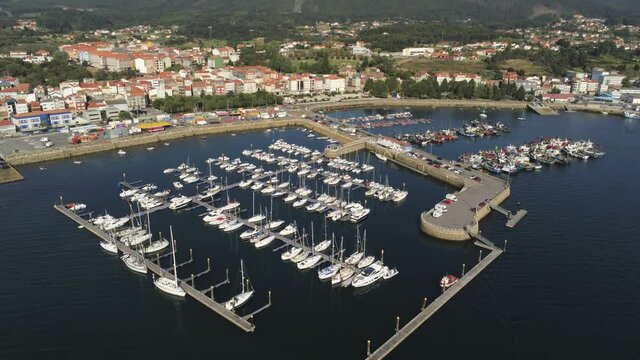 Boats in the marina. Coastal village of Galicia,Spain. Aerial Drone Video
