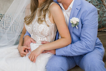 the bride and groom are sitting in chair