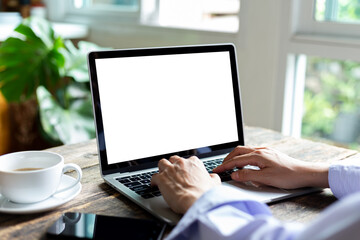 mock up business woman working empty screen computer on wood desk in Coffee shop