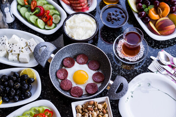 Traditional Turkish Breakfast with sausage egg pan on granite marble table.Close and large view         