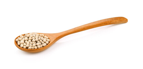 Pepper seeds in a wooden spoon on white background