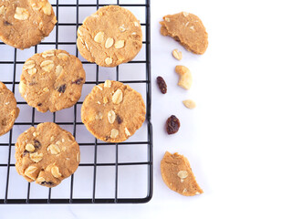 Healthy homemade oat cookies on a wire rack over marble table. Fresh from the oven, copy space..