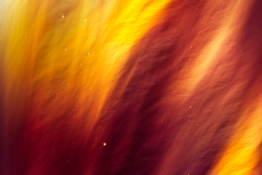 Fototapeta Mysterious abstract background in a warm autumn palette. Bright and colorful, it attracts attention with a combination of red and gold.