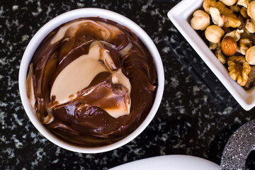 Detail shot of the breakfast table with cream chocolate on marble table
