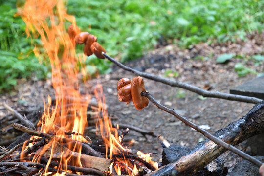 Toasting bacon in the forest on a hike on a natural fire