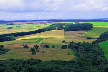 Light falls on farmland and moorland in Harwood Dale, North Yorkshire, England.
