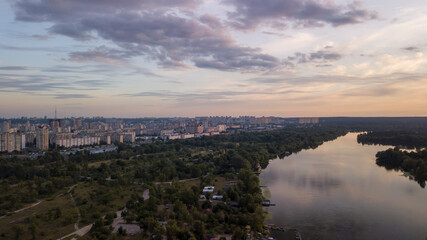 Aerial view of Kiev city with river and forest during sunset Ukraine. Beautiful sky