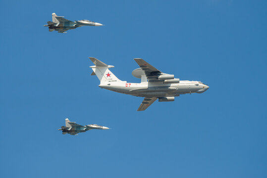 ST. PETERSBURG, RUSSIA - JULY 25, 2019: Aircraft A-50 "Liska" (RF-93966), accompanied by two Su-30SM multirole fighters
