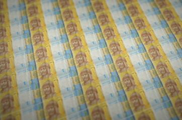 1 Ukrainian hryvnia bills printed in illegal money production conveyor. Collage of many fake bills....