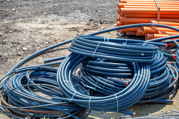 Coiled black PVC hoses with a blue lines