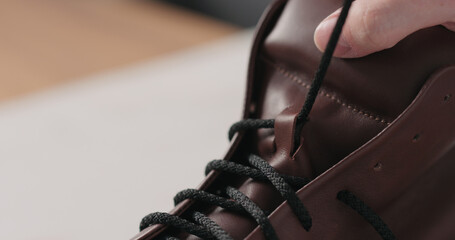 Fototapeta premium lacing leather sneakers after maintenance