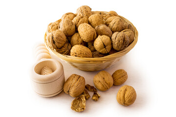 Walnuts in basket with crushing tool