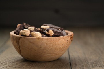 homemade dark chocolate with cashew in wood bowl
