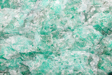 Light aquamarine stone background with microcracks, splashes of quartz and fine texture