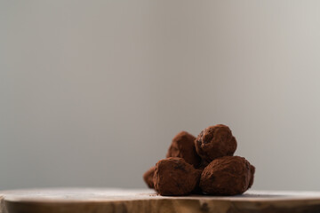 Handmade chocolate truffles on olive wwod board
