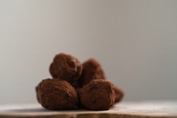 Handmade chocolate truffles on olive wwod board