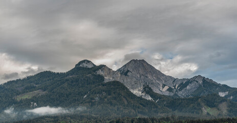 Gray Mittagskogel hill in summer cloudy dark day