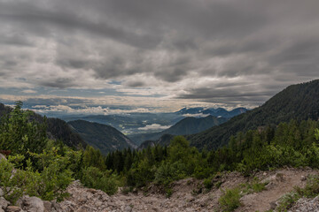 Fototapeta na wymiar View on Drau river valley from path to Mittagskogel hill in cloudy summer day
