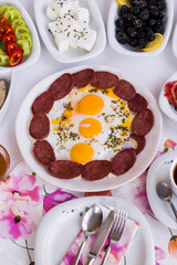 Traditional Turkish Breakfast egg with sausage on white of vertical image
