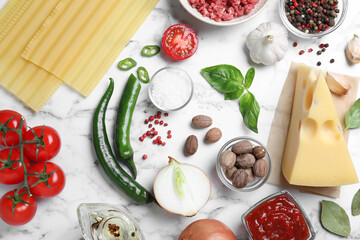 Fresh ingredients for lasagna on white marble table, flat lay