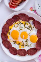 Traditional Turkish Breakfast egg with sausage on white of vertical image