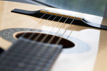 Obraz premium Acoustic guitar of yellow-brown color, close-up, top view