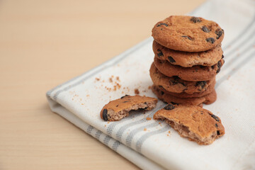 Tasty homemade cookies with chocolate chips on wooden table