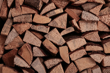 Stacked firewood as background, closeup view. Decorative material