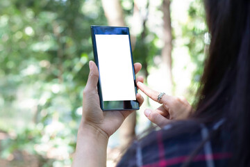 Business concept : Back view of young woman handing cell telephone with blank copy space scree  for advertising text.