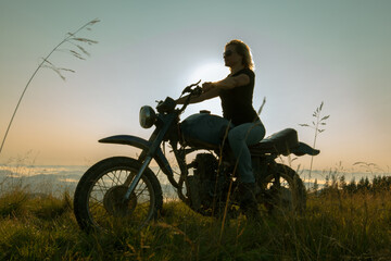 girl on a motorcycle travels in the mountains