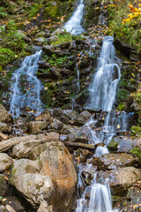 Mountain stream and rocky waterfall. Tourist and geological landmark. Waterfall Trufanets. Carpathians, Ukraine.