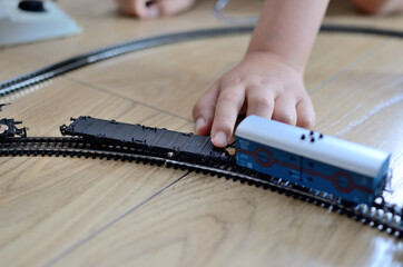 Toy train with child's hand