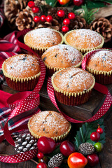 Christmas muffins covered powdered sugar on wooden table