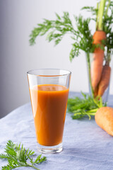 Natural carrot juice with pulp sugar-free in glasses on a table with a blue tablecloth