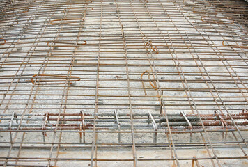 SELANGOR, MALAYSIA -MAY 13, 2016: Floor slab reinforcement bar arranged and tied together using tiny steel wire by the construction workers. 
