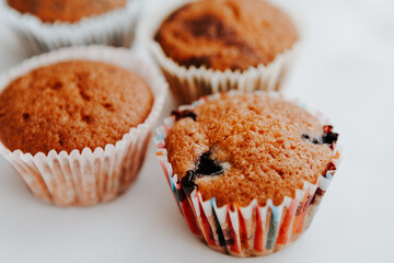 homemade muffins with different fillings on a light background. food for children's parties and tea