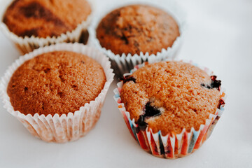 homemade muffins with different fillings on a light background. food for children's parties and tea