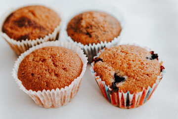homemade muffins with different fillings on a light background. food for children's parties and tea
