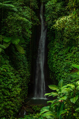Waterfall landscape. Beautiful hidden Leke Leke waterfall in Bali. Waterfall in tropical rainforest. Slow shutter speed, motion photography.