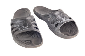 pair of used cheap black soft rubber slippers with signs od friction wear isolated on white...