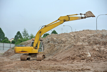 Fototapeta na wymiar MALACCA, MALAYSIA -MARCH 5, 2020: Excavators machine at the construction site. It is used to excavate soil and lifting material at the construction site. Powered by the hydraulic arm with a bucket. 