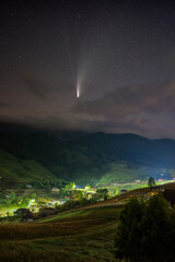 Comet C/2020 F3 NEOWISE over a mountain village in Romania