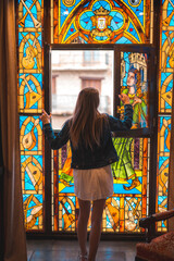 Young blonde caucasian woman in a white dress and denim jacket enjoying a beautiful medieval hotel in the town of Olite in Navarra. Spain, rural lifestyle. Opening the sale