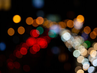 Abstract bokeh night light background, blurred lights traces from cars on road, defocused city traffic on street at night