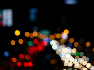 Abstract bokeh night light background, blurred lights traces from cars on road, defocused city traffic on street at night